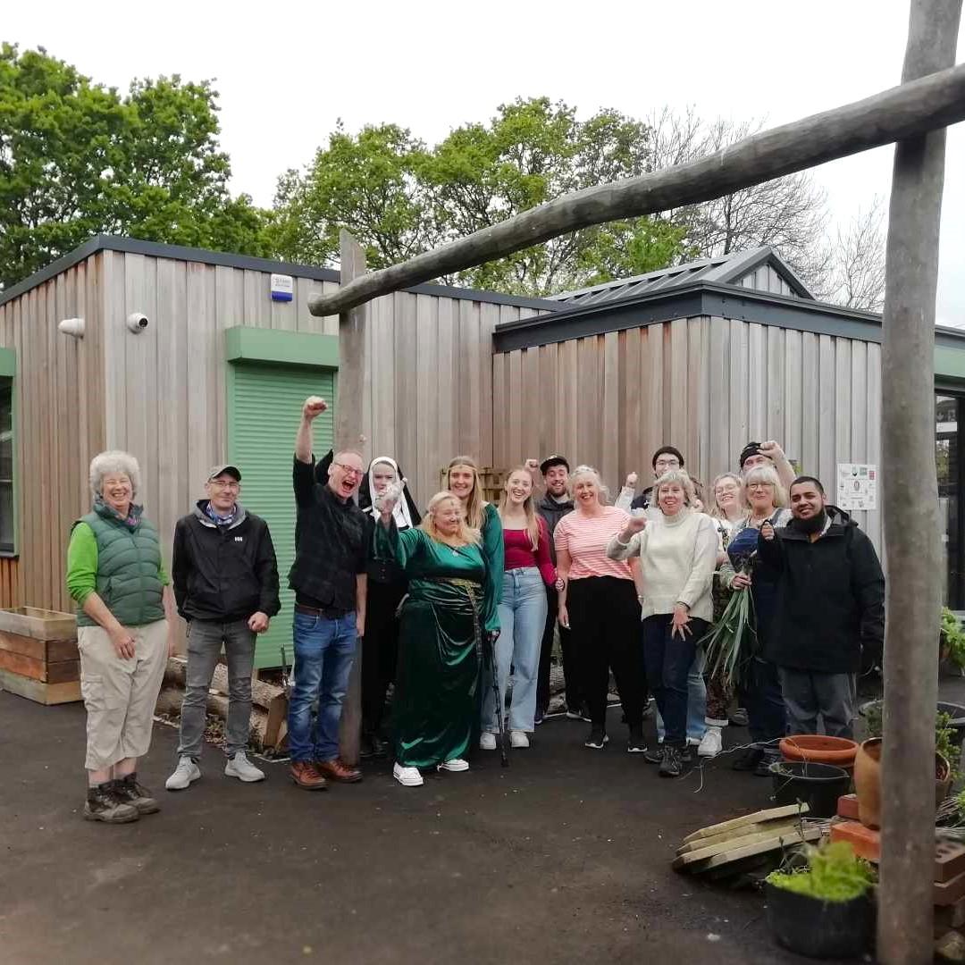 A group of people standing together and smiling at the camera