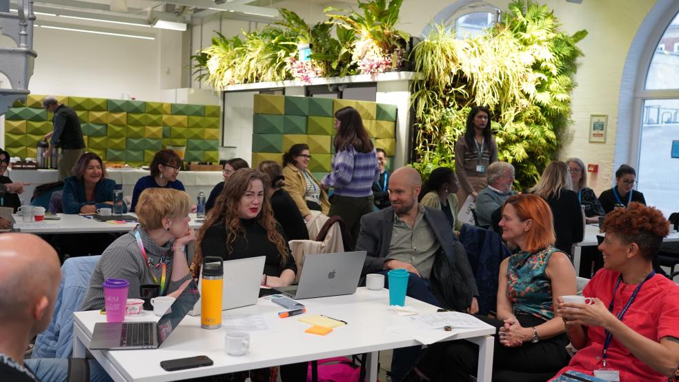 People sat around a table taking part in a discussion
