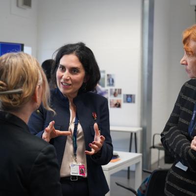 Three people stood up talking to each other