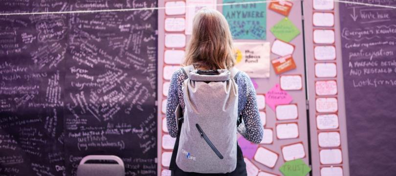 Woman evaluating qualitative data on ideas board