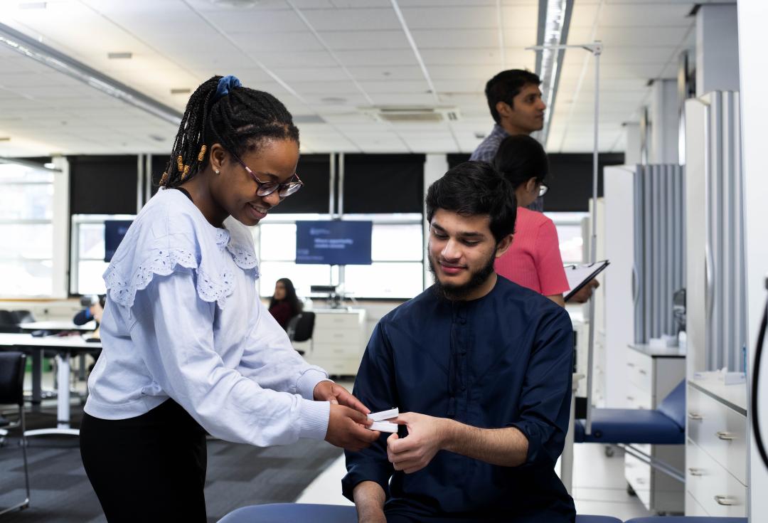 Students working in a pharmacy context