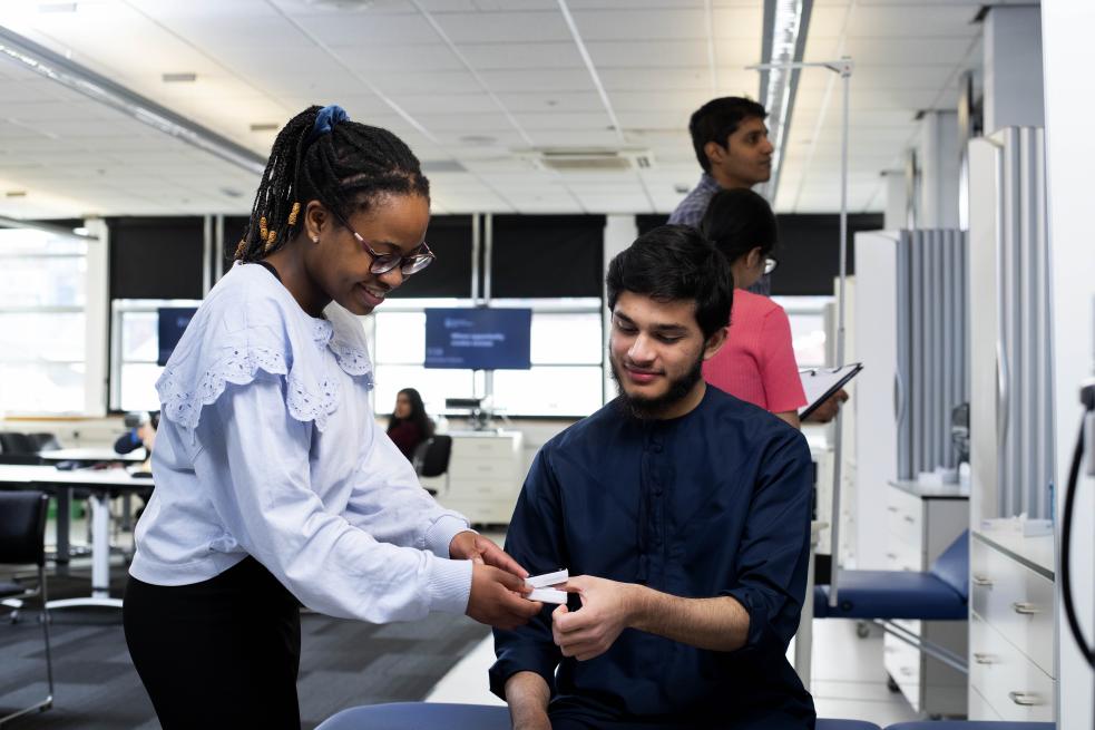 Students working in a pharmacy context