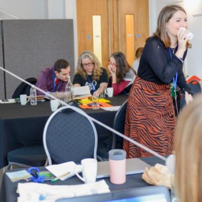 Delegates on the Engage Academy doing an activity that involves listening and talking through plastic cups attached to pieces of string