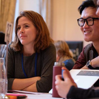 In-person event attendees sitting around a table