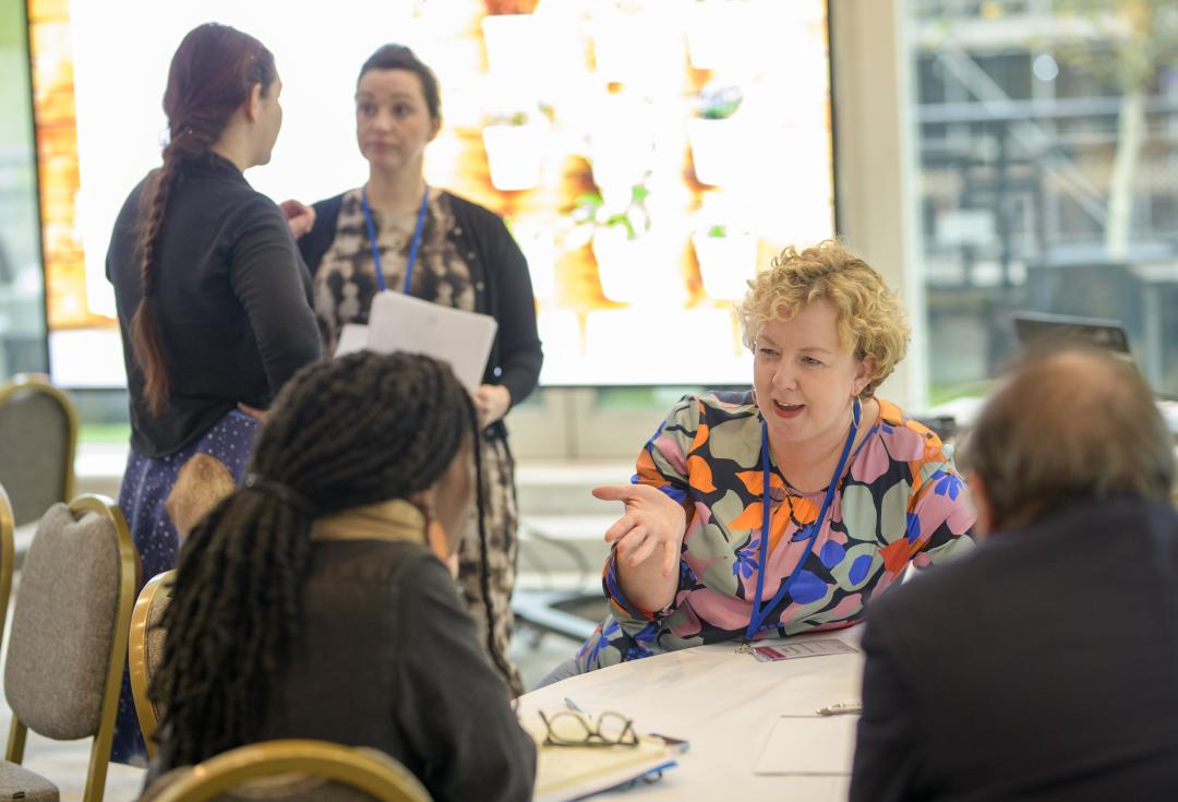 Woman speaking to table during training