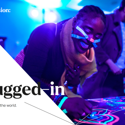Poster from Birmingham's public engagement stragegy: photo of a person taking part in an activity with lights, with text saying: Our vision: to make Birmingham the most plugged-in university in the world.