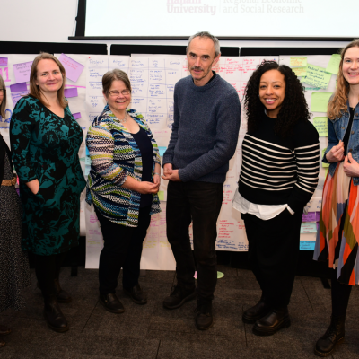 Ann, Zoe, Sophie, Paul, Gemma and Asphodel standing together and smiling at the NCIA action learning event