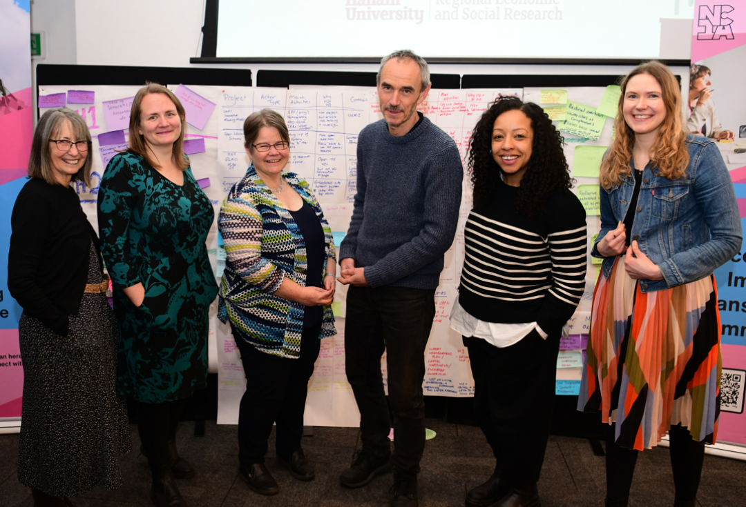 Ann, Zoe, Sophie, Paul, Gemma and Asphodel standing together and smiling at the NCIA action learning event